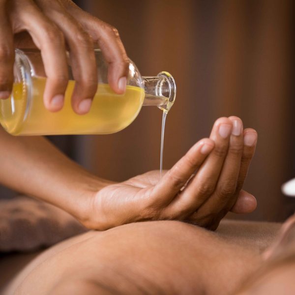 therapist-pouring-massage-oil-spa (1)